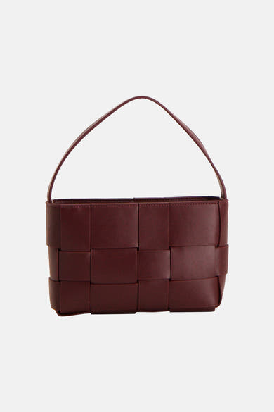 Red woven leather handbag with structured rectangular shape and top handle, front view