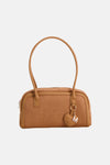 Cognac suede handbag with rounded top handle and heart-shaped charm by Mora, front view