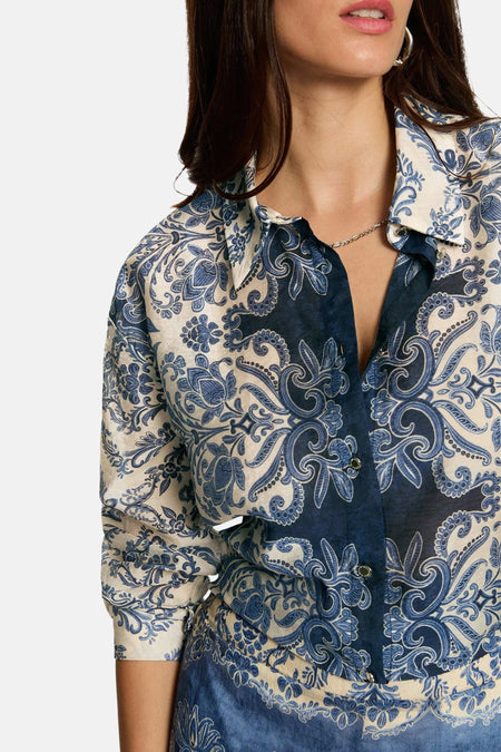 Multicolored long-sleeve blouse with blue floral paisley print by Morgan de Toi, featuring button front and ruffled collar, shown in close-up side view