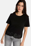 Black short-sleeve t-shirt with lace hem detail, worn with gray jeans, front view