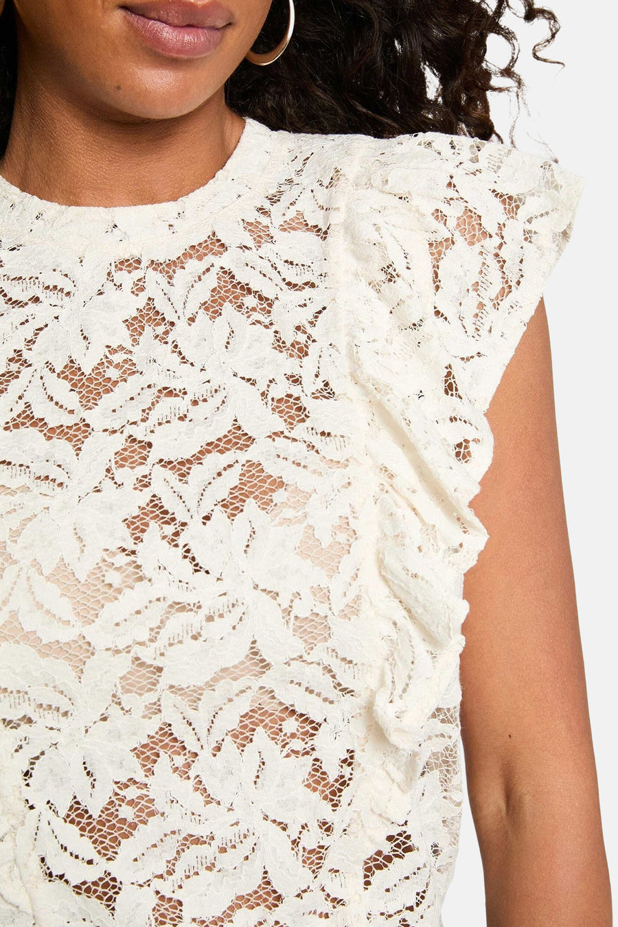 Ecru lace short-sleeve blouse with floral pattern and ruffled sleeves, close-up front view