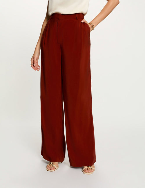Orange wide-leg suit trousers by Morgan de Toi, smooth fabric, high waist, front pleats, full-length view