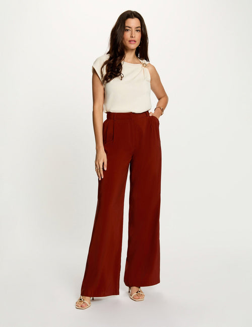 Orange wide-leg suit trousers by Morgan de Toi, featuring high waist, front pleats, and smooth fabric, worn with cream top and sandals in full-length front view.