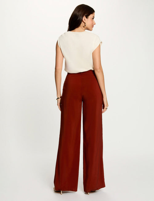 Orange wide-leg suit trousers by Morgan de Toi, back view, smooth fabric, high waist, model wearing cream top and heels
