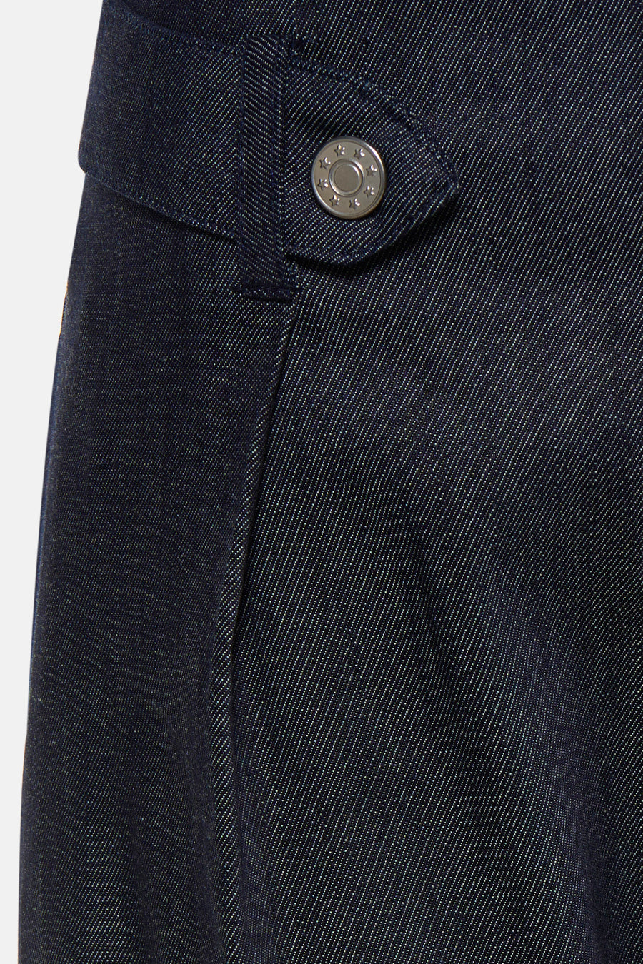 Dark blue denim jeans by PJAMES, close-up of front pocket with star-embossed silver button, textured twill weave, side view