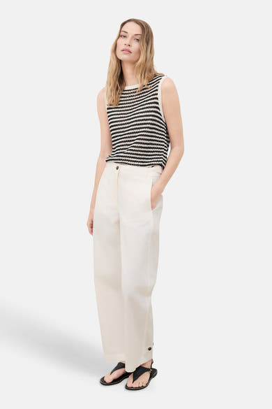 Beige wide-leg trousers with front pockets and buttoned cuffs, worn with a striped knit top and black sandals, full-length front view