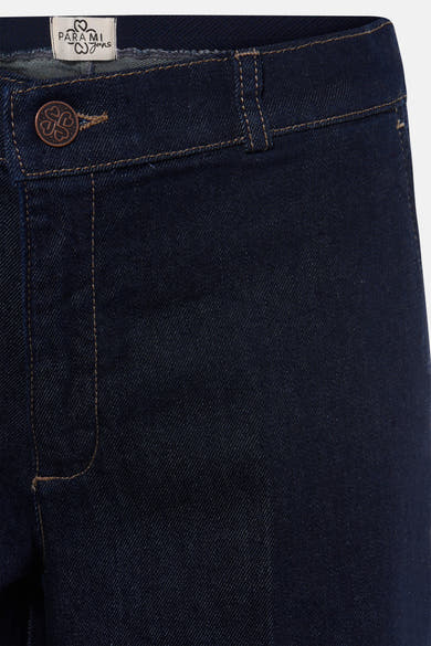 Dark blue denim jeans by Parami, featuring copper button and contrast stitching, close-up front view