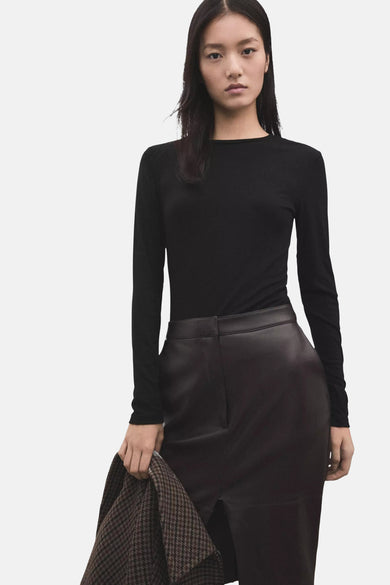 Black long-sleeve fitted t-shirt with round neckline, worn by model with leather skirt and houndstooth coat, front view