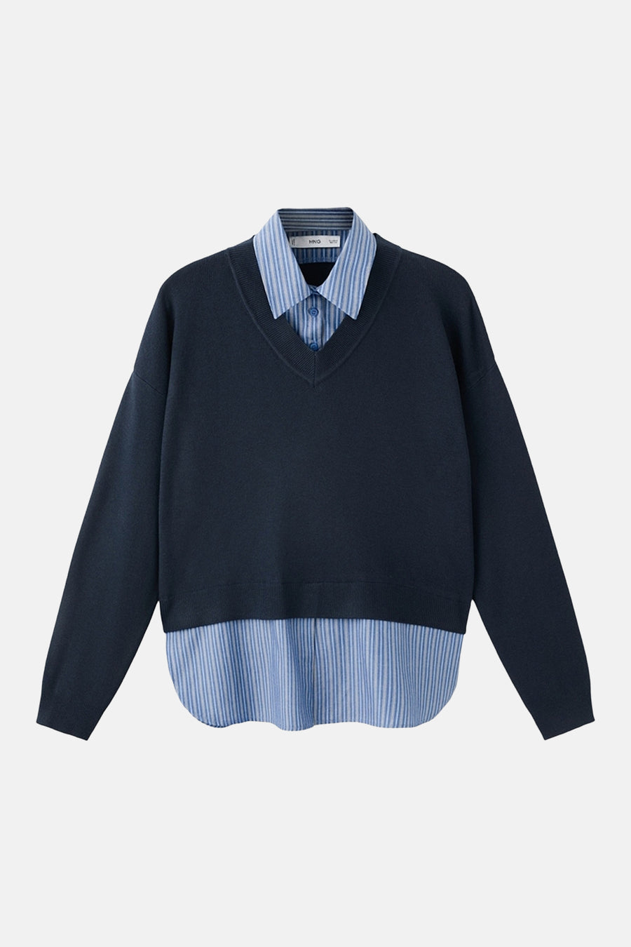 MANGO blauwe V-hals trui, gedragen over een blauw-wit gestreept overhemd.