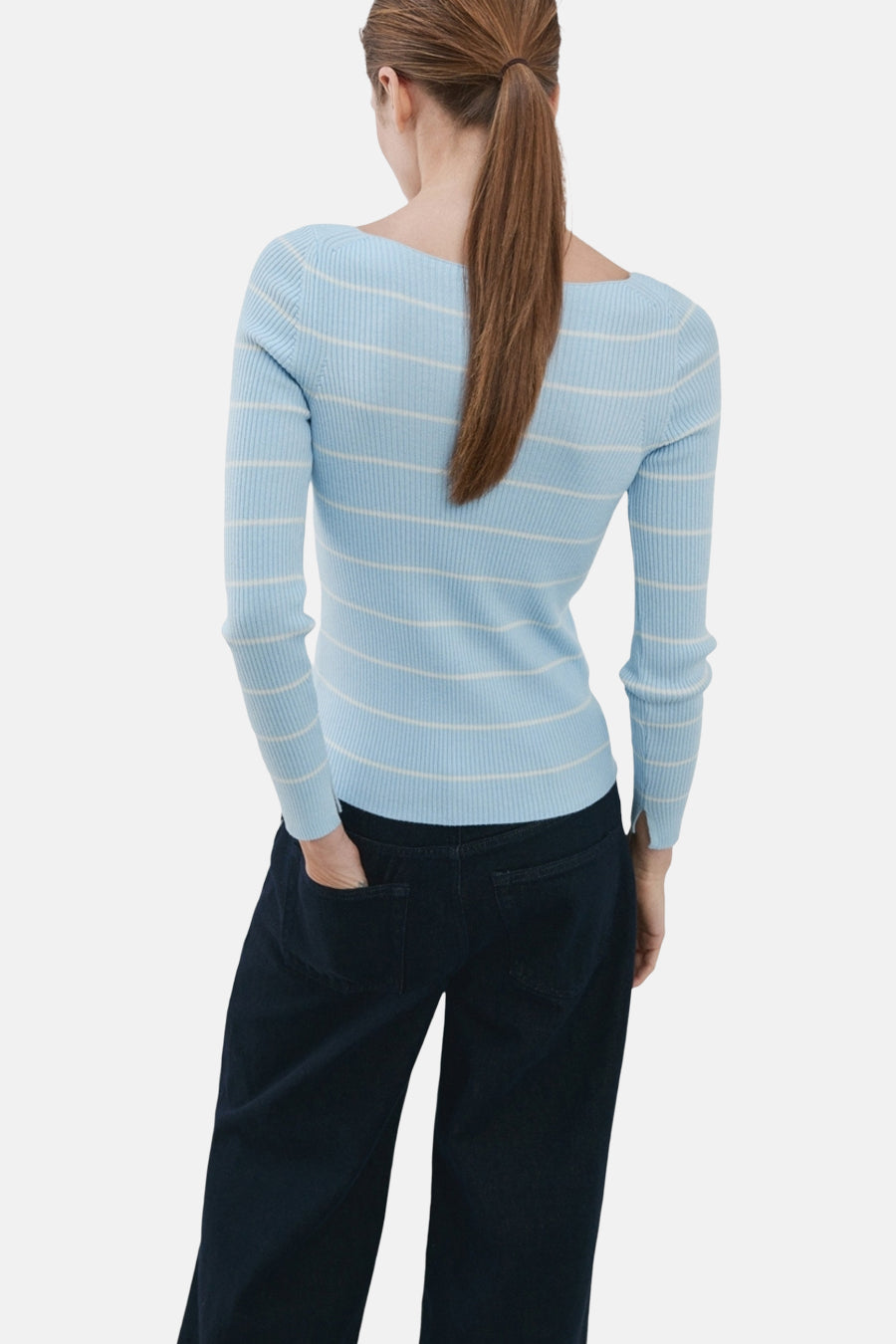 Pull à col rond multicolore de MANGO, rayé bleu et blanc, porté avec un jean bleu foncé, vue de dos.
