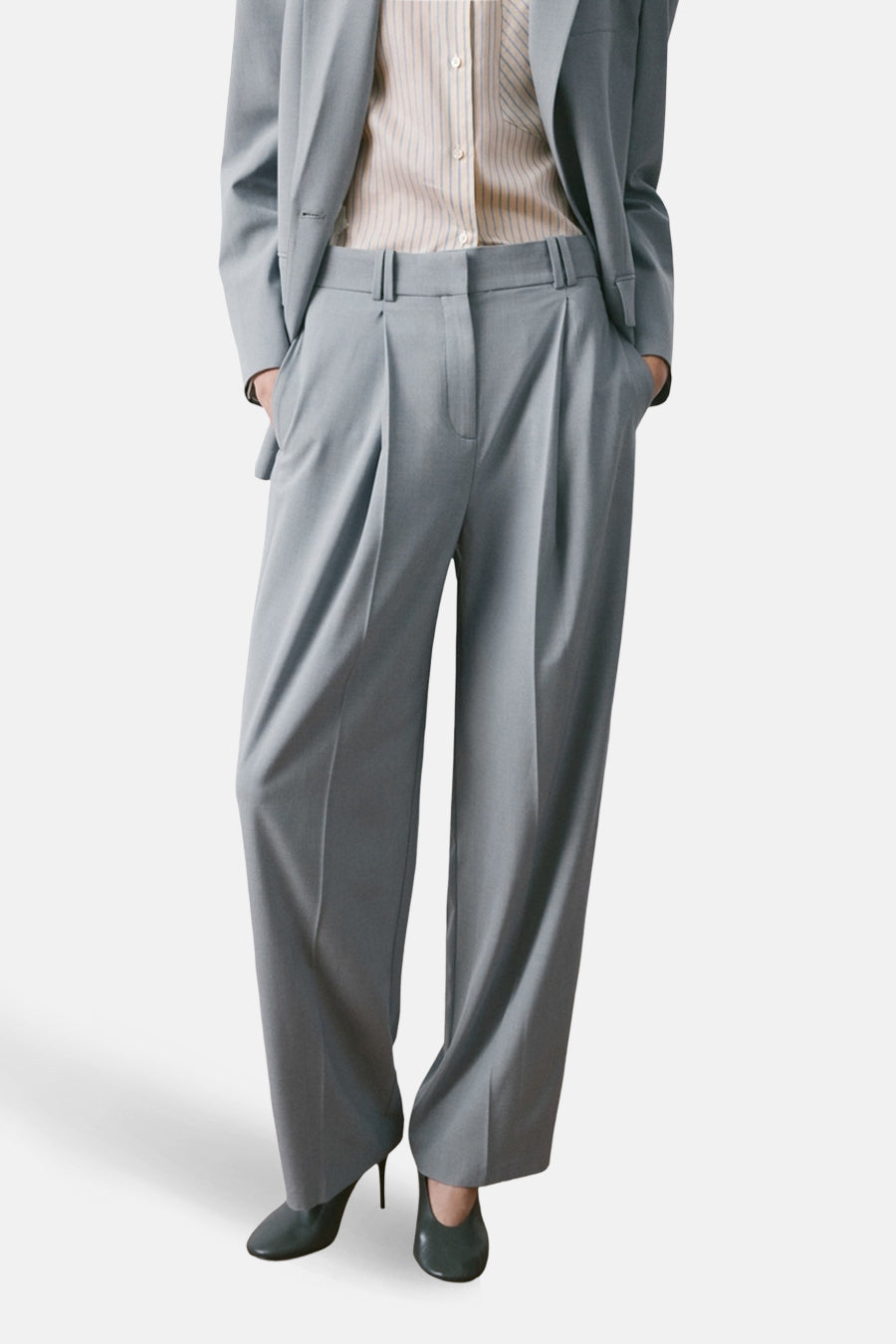 Blauwe pantalon van MANGO, wijde pasvorm, met een gestreept overhemd en naaldhakken.