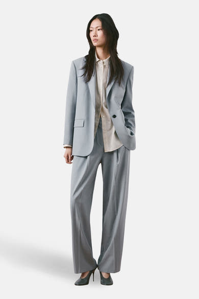 Blauwe pantalon van MANGO, rechte pasvorm, gedragen met een gestreept overhemd en pumps.