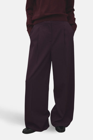 Pantalon bordeaux ample by MANGO, avec poches latérales et ourlets larges.