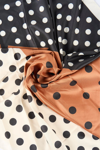 Foulard multicolore de MANGO avec motif à pois noirs et blancs sur fond beige et marron.
