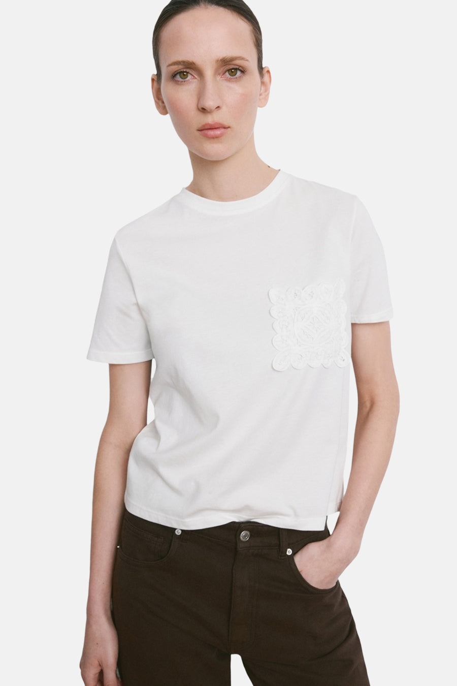 Wit T-shirt van MANGO, gedragen met een losse bruine broek, achterzicht.