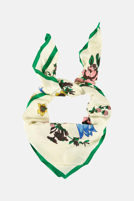 Foulard multicolore de MANGO avec bordure verte, motif floral et détails noués.
