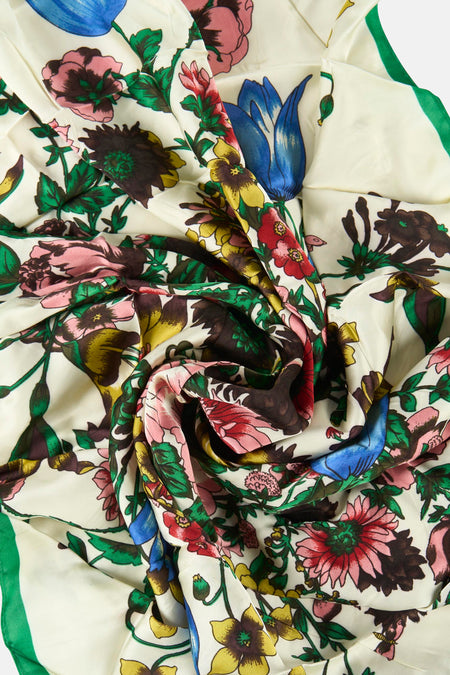 Foulard multicolore de MANGO, avec un motif floral complexe et un bord vert contrastant.
