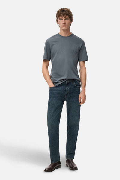 T-shirt bleu à manches courtes de MANGO, porté avec un jean et des chaussures marron.
