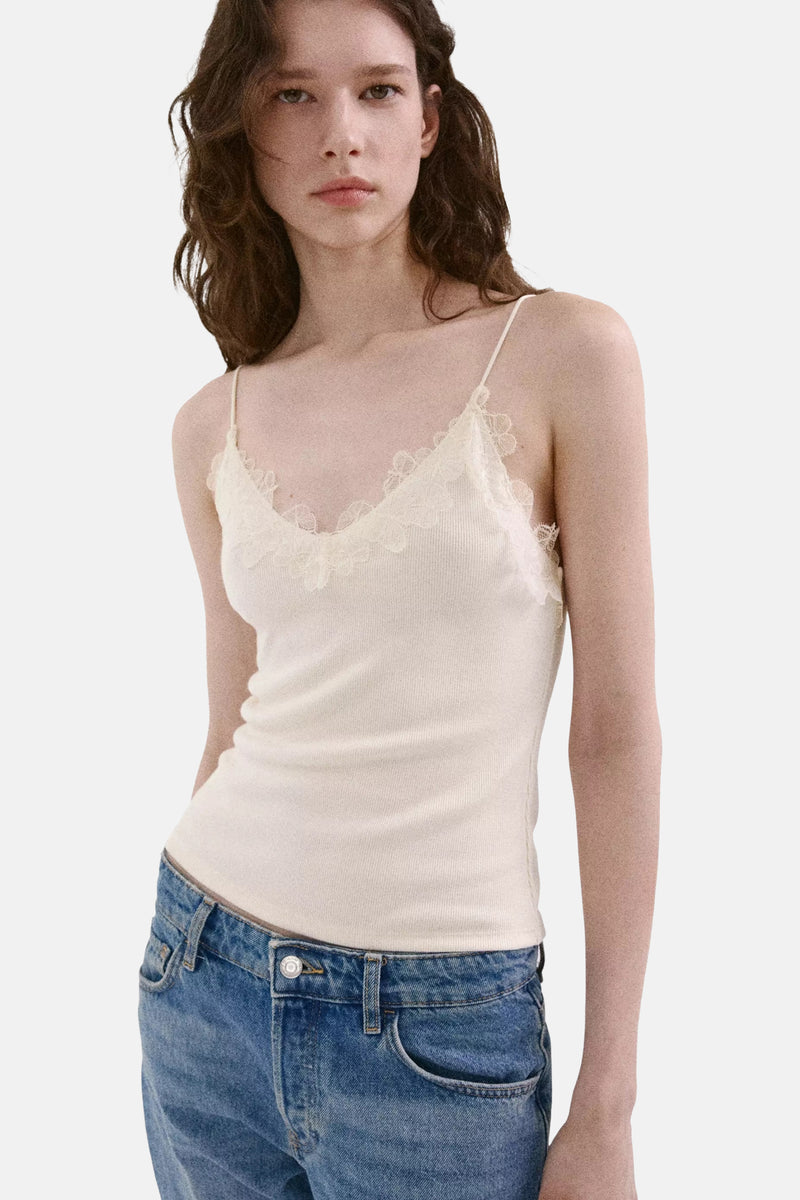 Écru ribbed camisole with floral lace trim, front view, paired with blue jeans