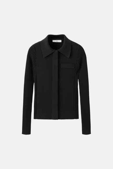 Gilet noir de MANGO, coupe courte à col chemise et manches longues côtelées.