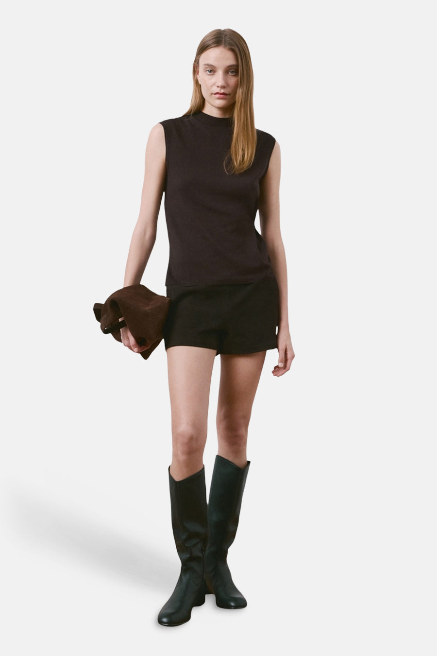 Top sans manches brun de MANGO, porté avec un short noir et des bottes hautes.