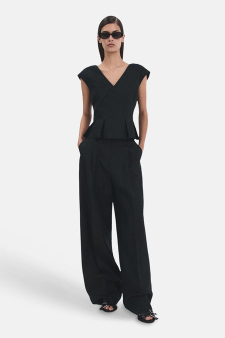 Blouse bleu foncé sans manches de MANGO, avec coupe péplum et col en V profond.