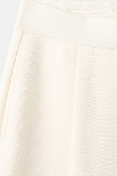 Jogging beige de MANGO, avec une poche visible et une texture subtile en gros plan.
