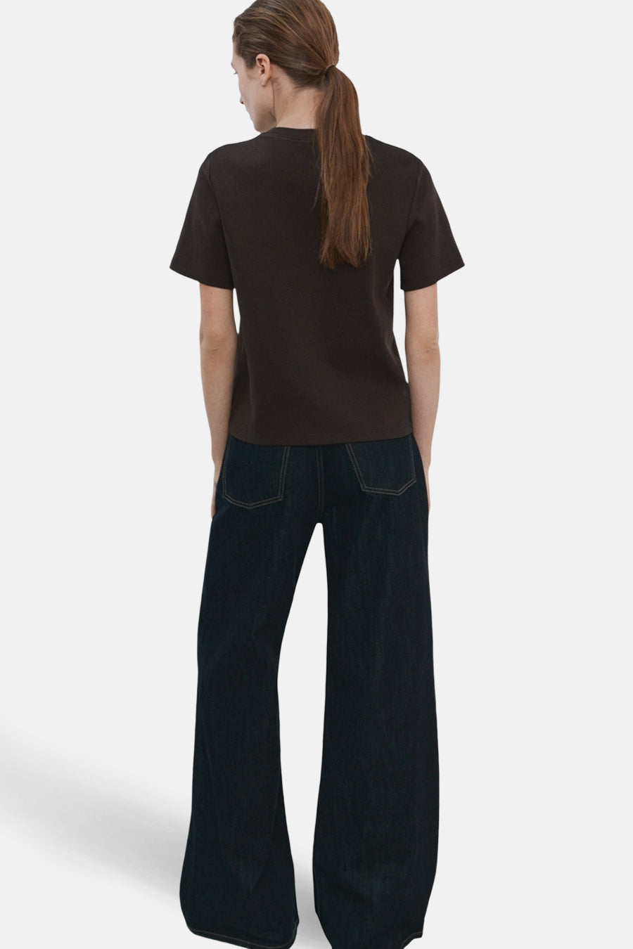 T-shirt à manches courtes brun de MANGO, vue arrière avec un pantalon large bleu foncé.