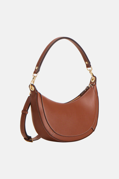 Sac à main brun par MANGO, avec une bandoulière réglable et finitions cousues apparentes.
