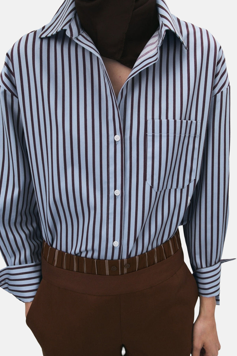 Chemise à manches longues multicolore de MANGO, à rayures verticales bleu et marron, avec poche poitrine.
