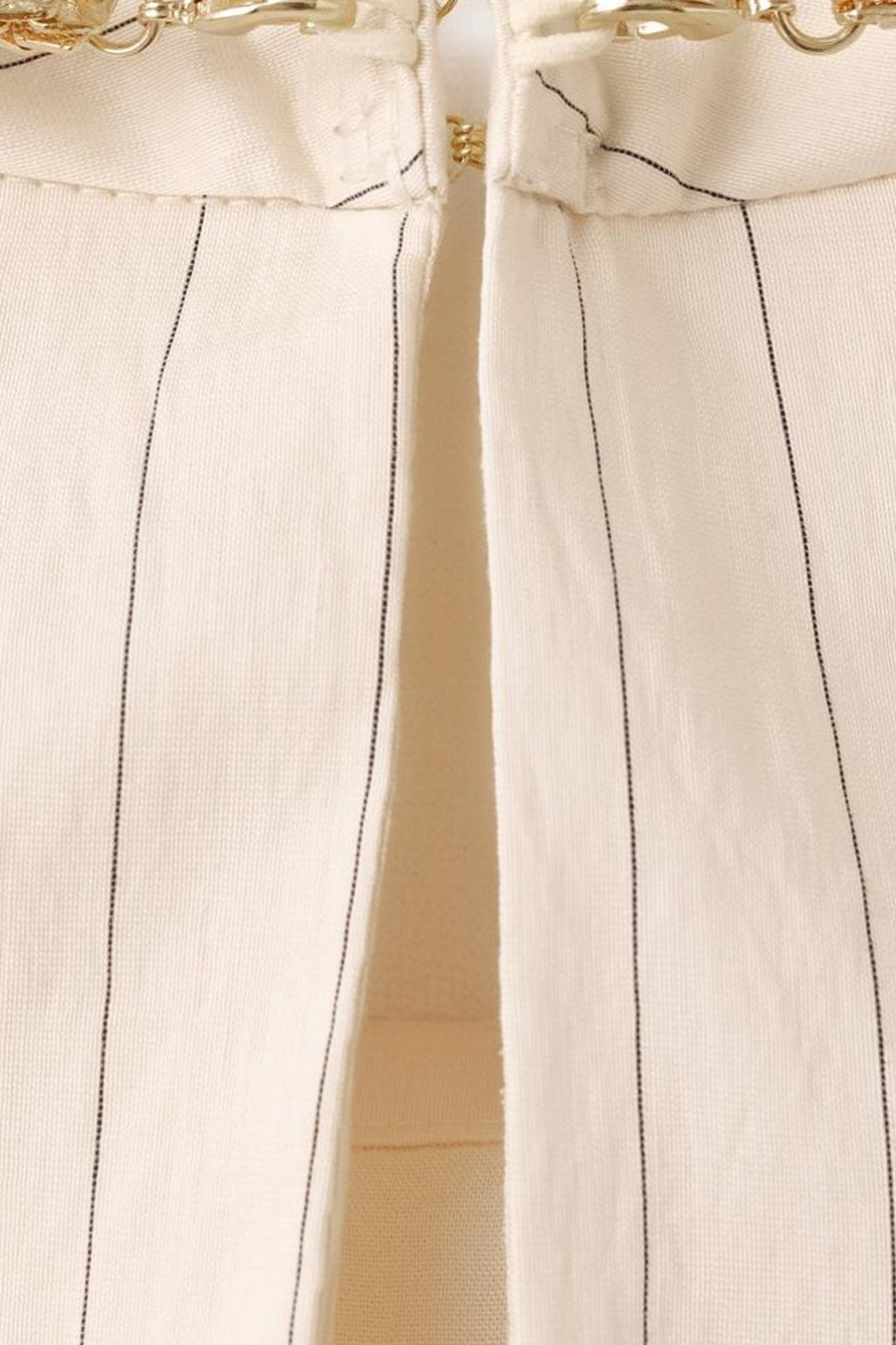 Ecru blouse van MANGO met fijne zwarte verticale strepen en gouden kettingdetail bij de kraag.