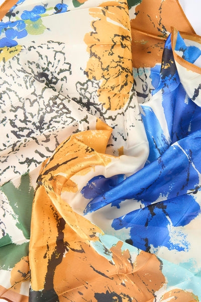 Foulard multicolore de MANGO, motif floral abstrait avec des touches de bleu, jaune et vert.
