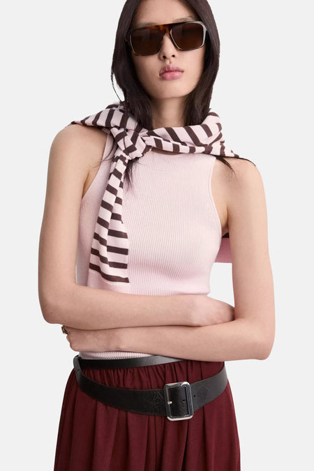 Top sans manches rose côtelé de MANGO, porté avec une écharpe rayée, jupe bordeaux, ceinture noire et lunettes de soleil.
