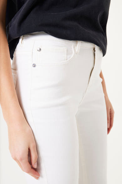 Short chino blanc de GARCIA, avec fermeture éclair et détails de rivets argentés, porté avec un t-shirt noir.