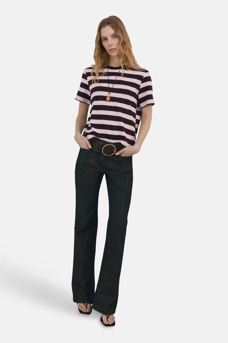 T-shirt à manches courtes multicolore de MANGO, rayures horizontales roses et noires, porté avec un jean taille haute et un collier.
