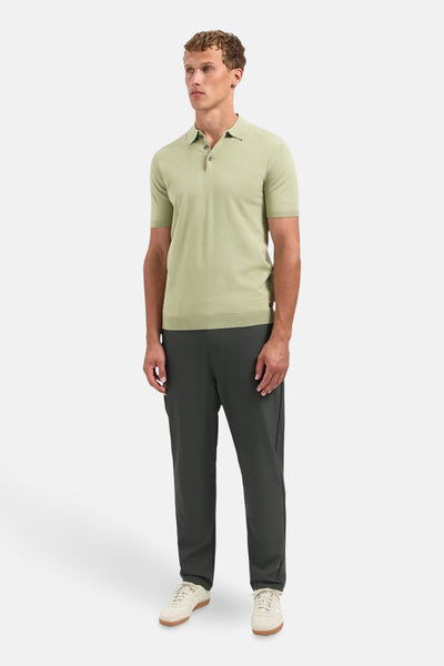 Pull vert par NO EXCESS, porté avec un pantalon de couleur foncée et des baskets beiges.
