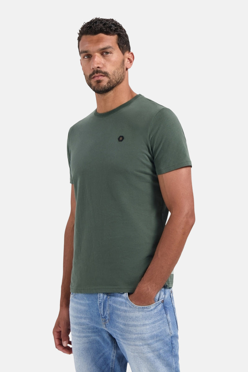 Kaki T-shirt met korte mouwen van NO EXCESS, gedragen met een casual spijkerbroek, hand in de zak.