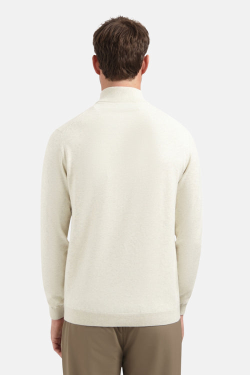 Beige coltrui van NO EXCESS, in fijne breitechniek, gedragen met een bruine broek.