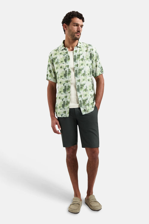 Groen overhemd met korte mouwen van NO EXCESS, met bloemenpatroon, gedragen met een effen wit T-shirt en een antracietkleurige korte broek.