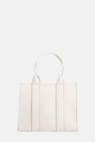 Sac à bandoulière blanc de Tamaris avec des poignées arrondies et texture grainée.