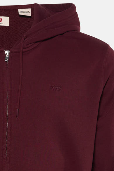 Bordeaux zip-up hoodie by Levi's with ribbed texture, front zipper, and small embroidered logo on chest, close-up view