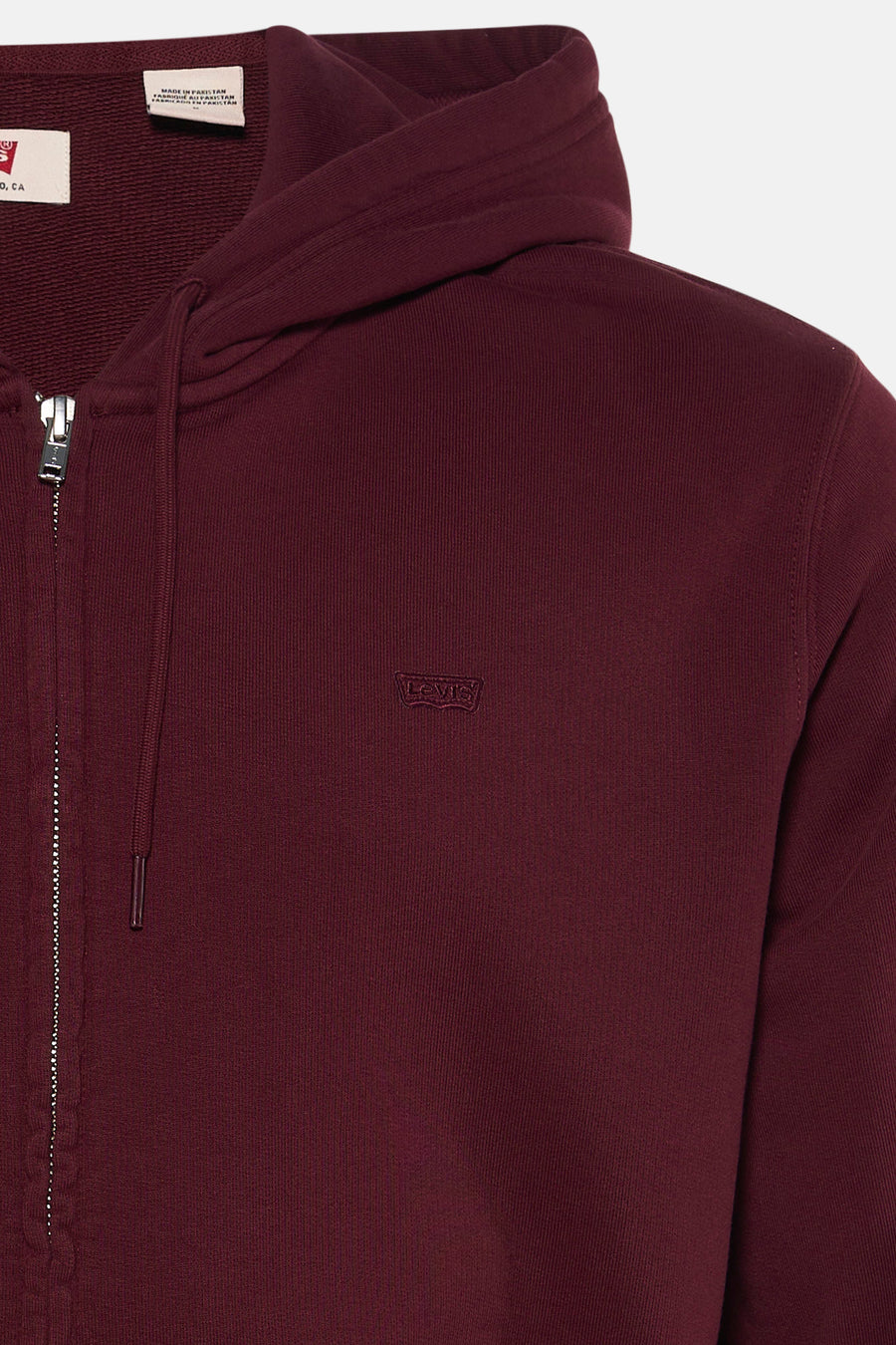Bordeaux zip-up hoodie by Levi's with ribbed texture, front zipper, and small embroidered logo on chest, close-up view