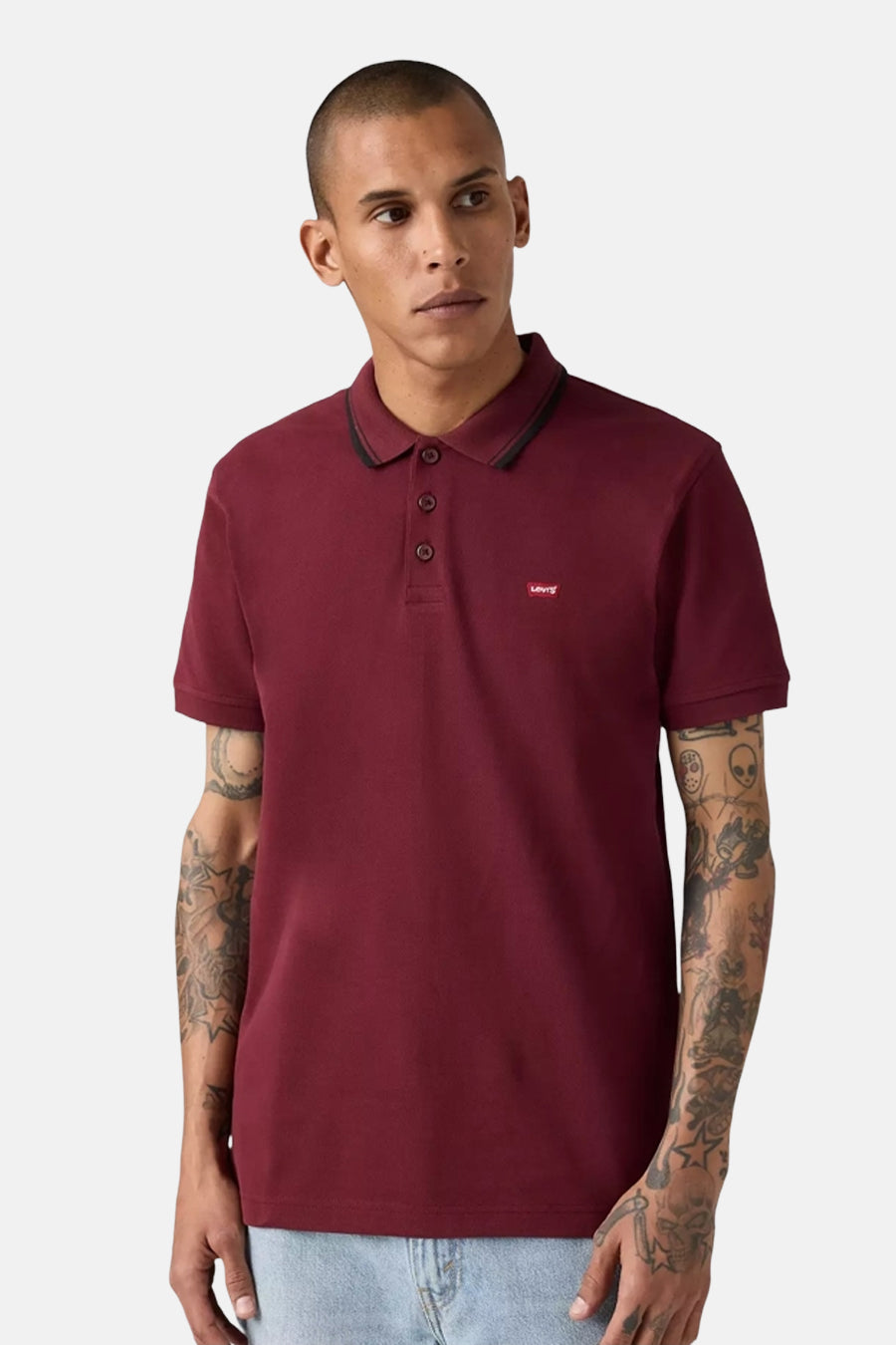 Bordeaux short-sleeve polo by Levi's with black collar trim and chest logo, worn with light blue jeans, front view
