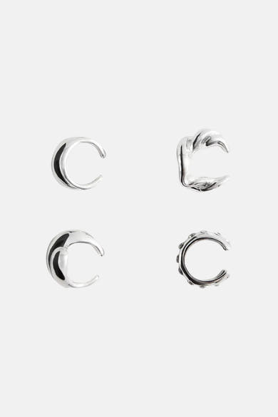 Silver-toned hoop earrings with textured and smooth finishes, featuring crescent and scalloped designs, displayed in top-down view.