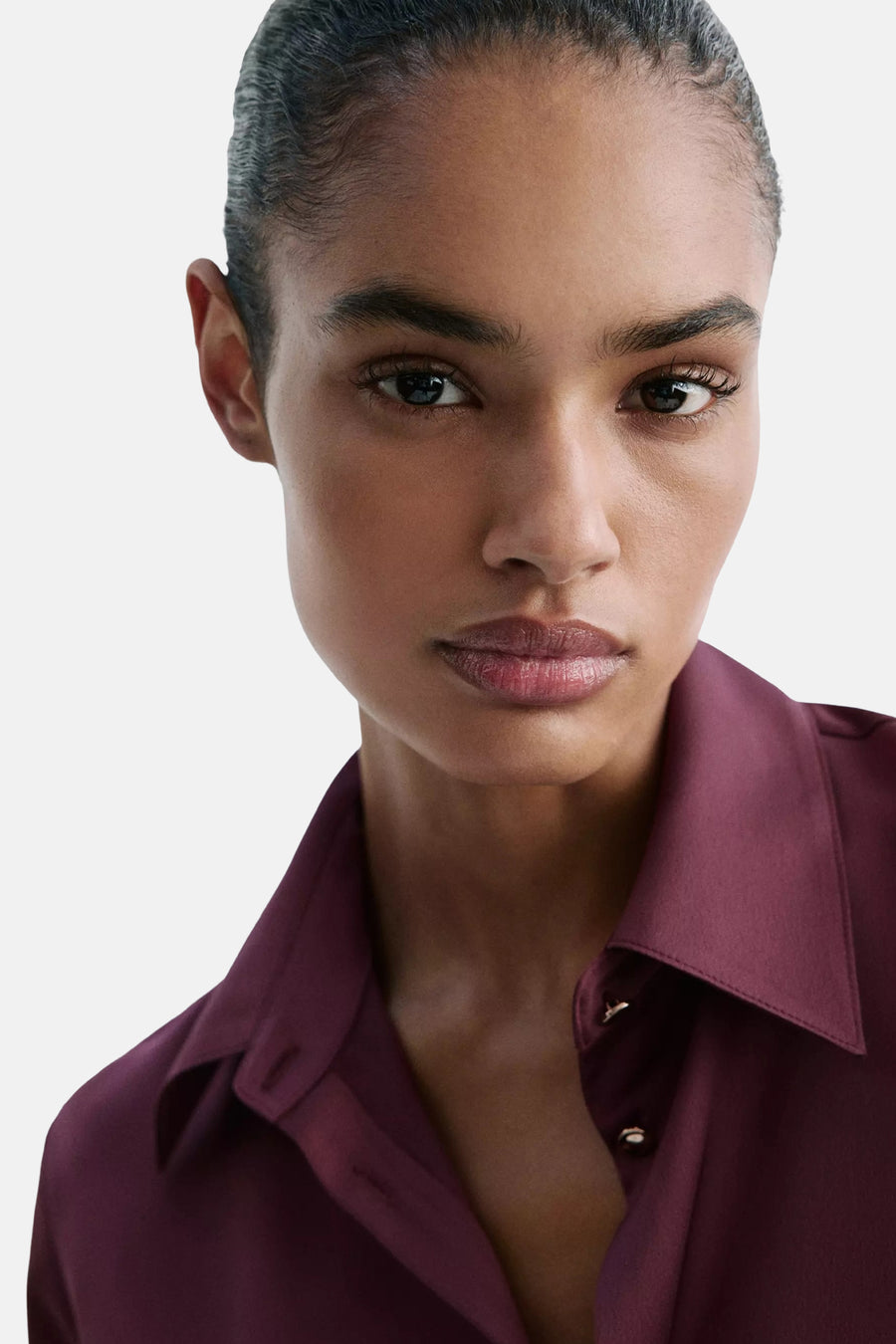Bordeaux long-sleeve blouse with pointed collar and button placket, cropped front view on model