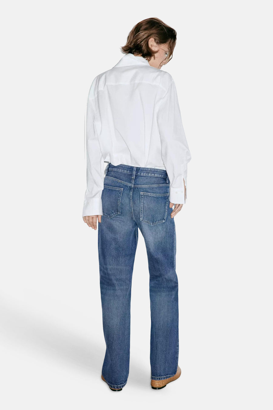 Dark blue straight-leg denim jeans by MIAMI, back view, featuring classic stitching and two rear pockets, worn with a white shirt.