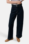 Dark blue wide-leg denim jeans by CATHERIN, featuring clean stitching and cuffed hems, shown on model with gray top and tan loafers.