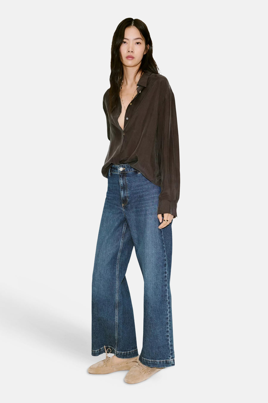 Dark blue wide-leg denim jeans by CATHERIN, full-length front view, worn with dark blouse and beige suede shoes