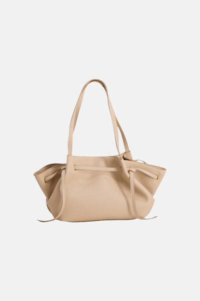Beige leather shoulder bag with gold-tone hardware and drawstring closure, front view