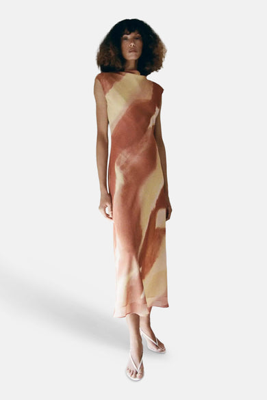 Multicolored sleeveless midi robe by MANGO with abstract watercolor pattern, flowing silhouette, and asymmetrical neckline, shown on model in full-length front view.
